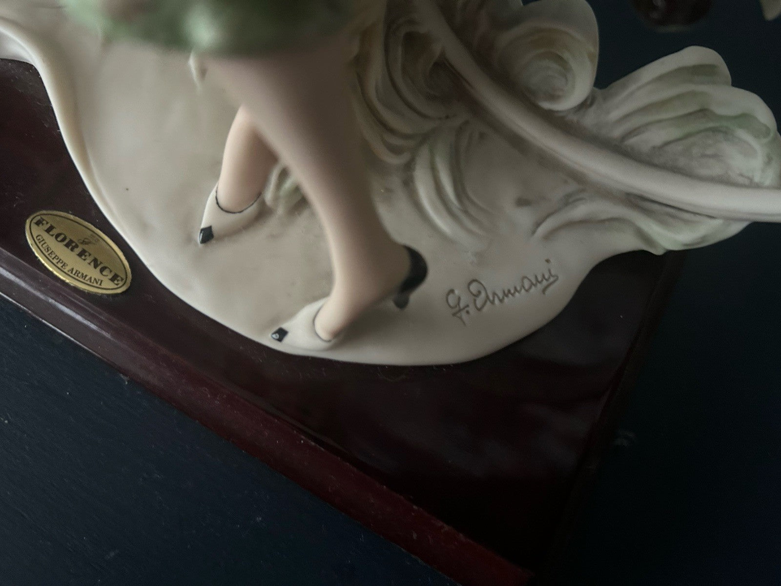 This figurine is a Giuseppe Armani sculpture titled "The Bicycle - Spring"